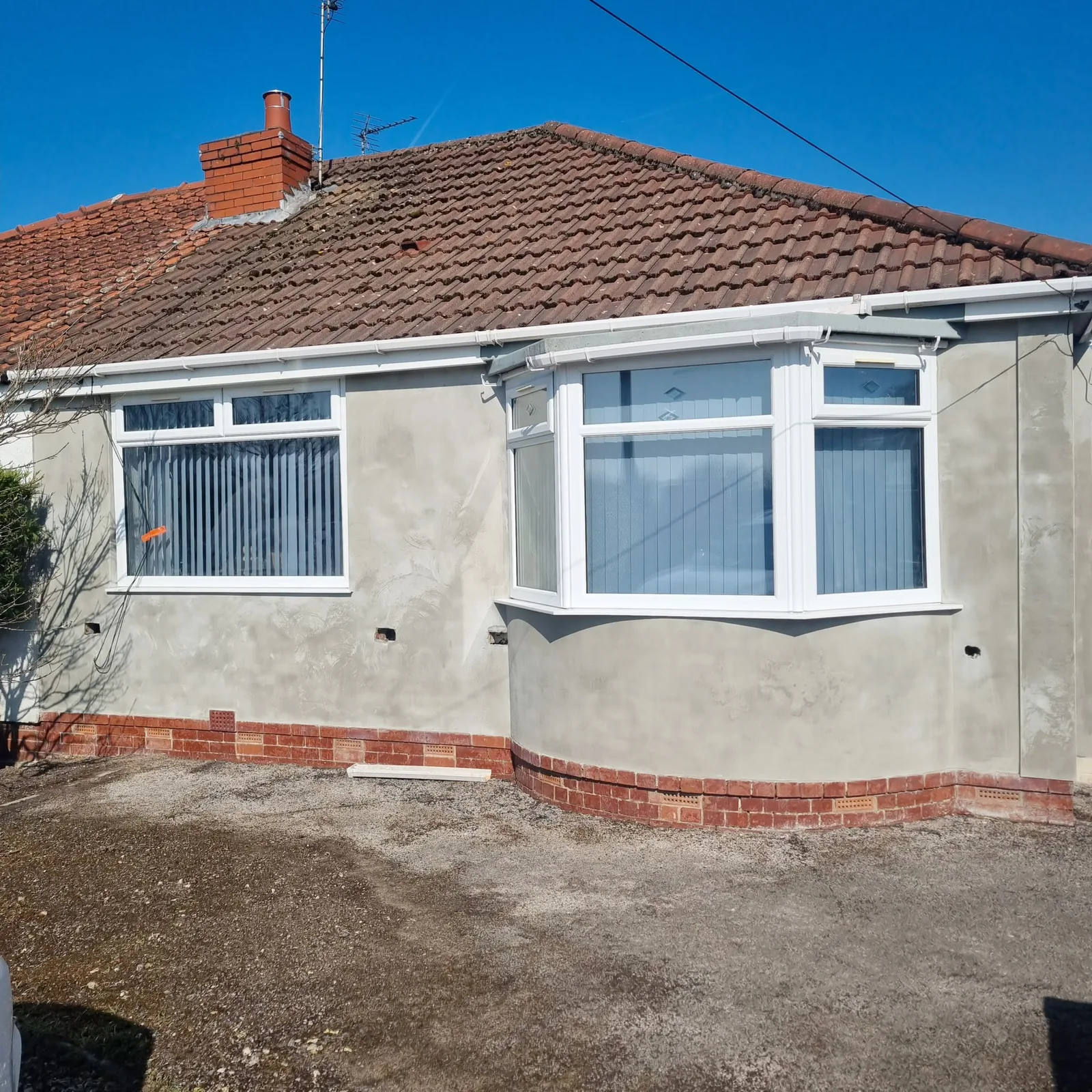 Basecoat complete across a bungalow frontage, ready for the top coat, Southport