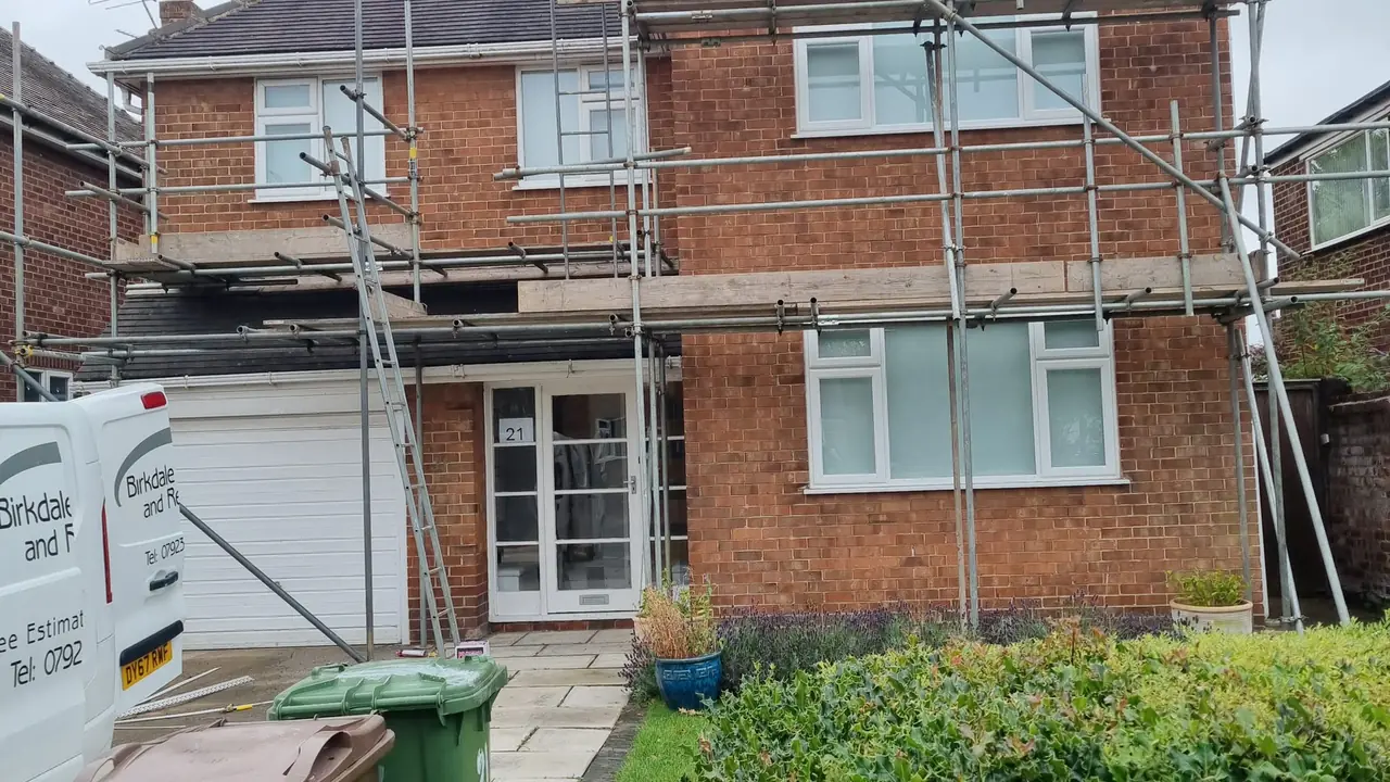 Detached house in Birkdale in bare red brick with the scaffold up before rendering