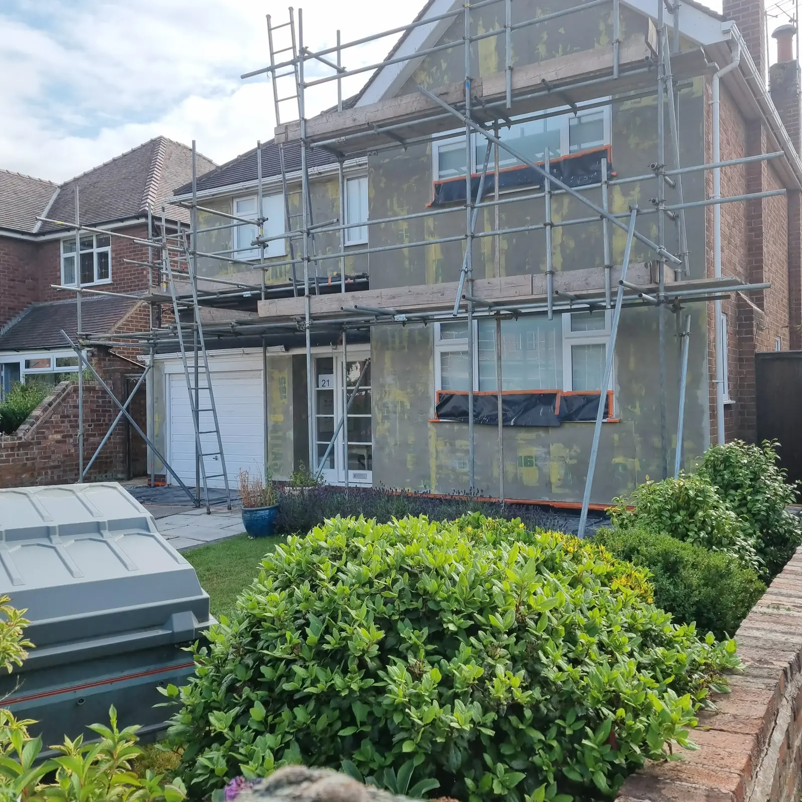 Insulation boards and mesh basecoat across the front of a Birkdale detached house