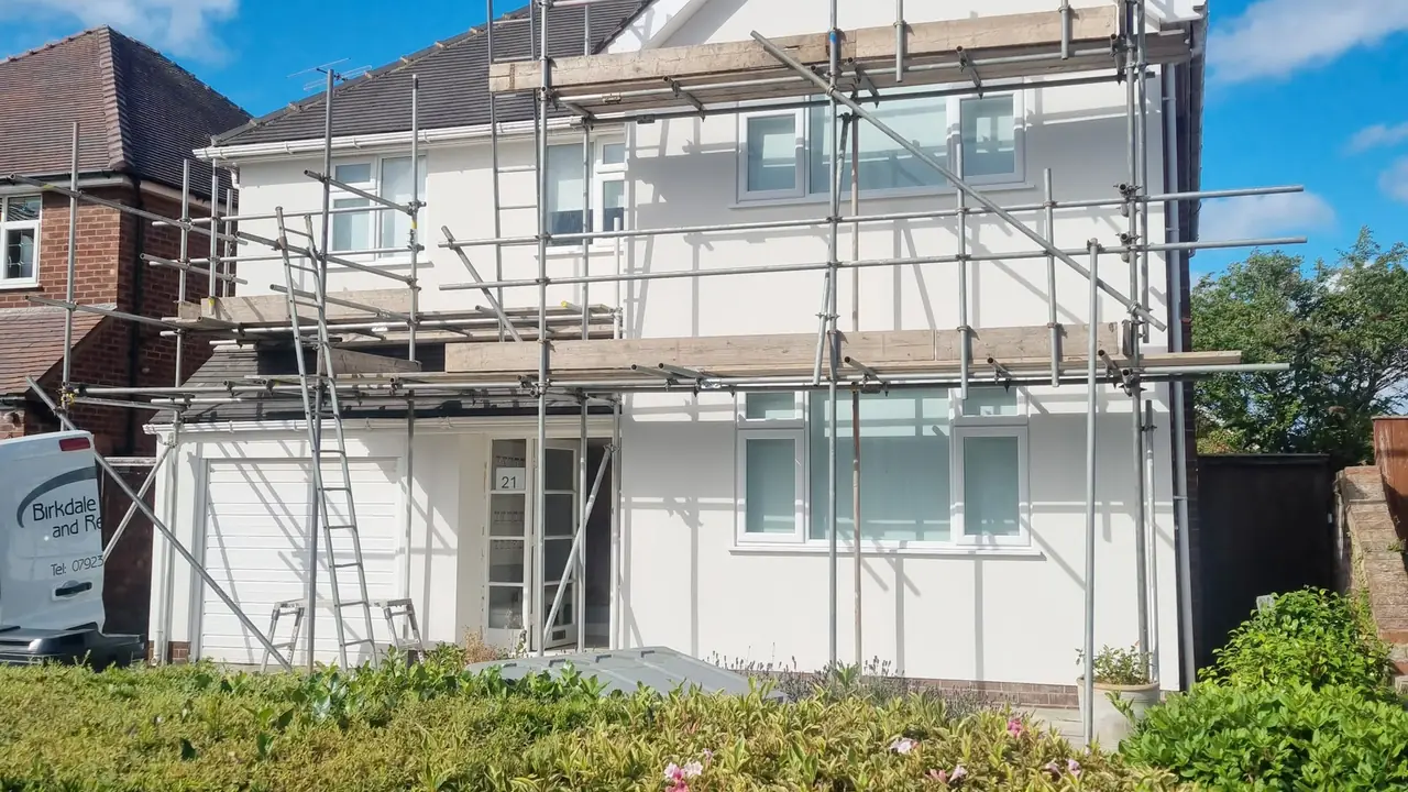 The same Birkdale detached house finished in white render with the scaffold still up