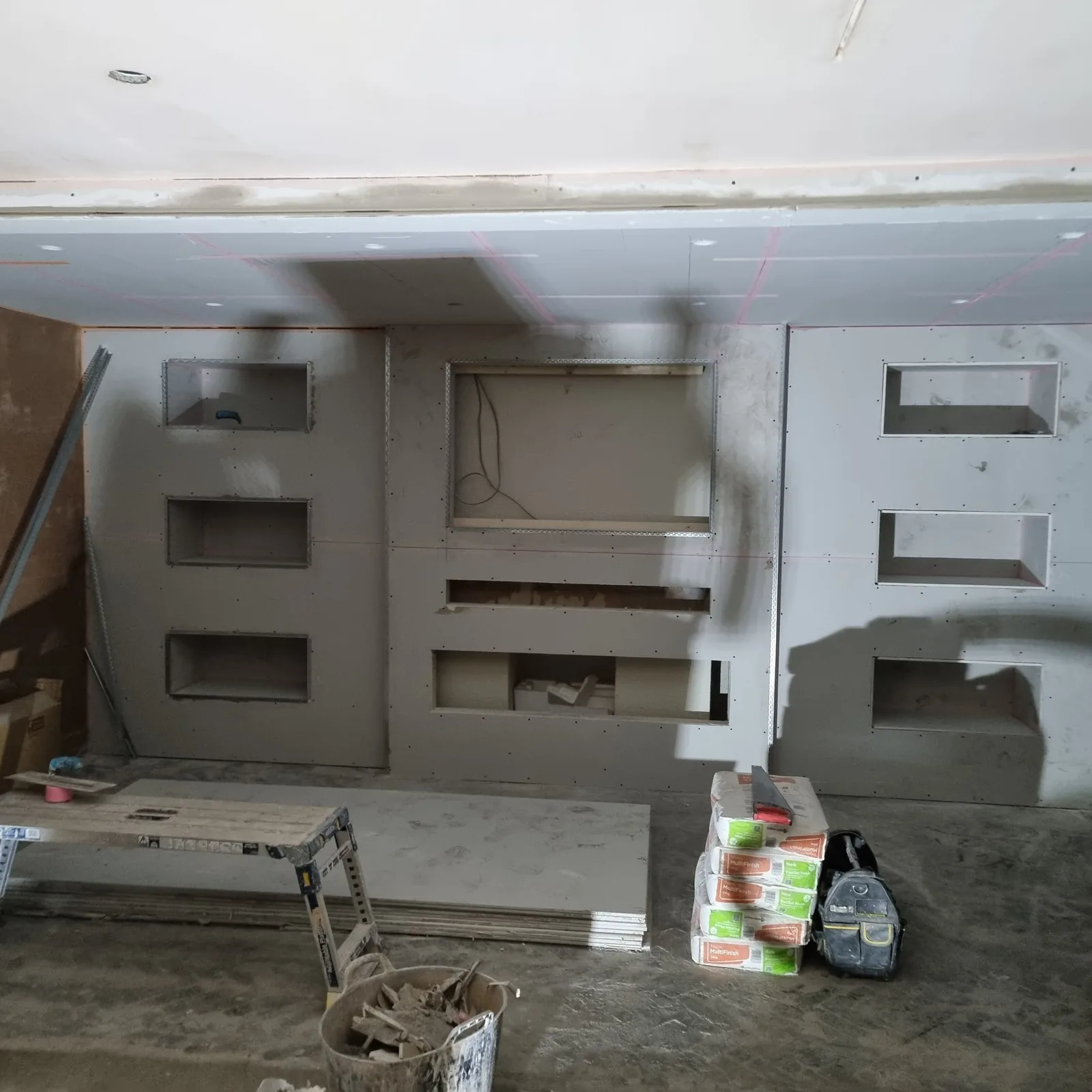 Full-width media wall plasterboarded with beads before skimming, Southport