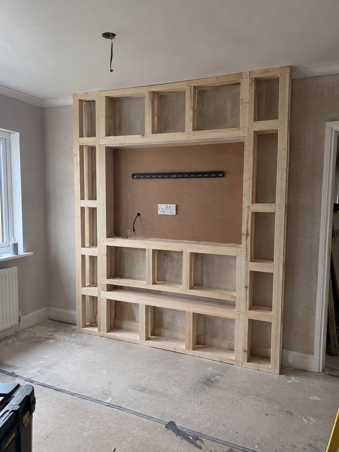 Media wall in Southport before, timber stud frame with the TV bracket and socket set out
