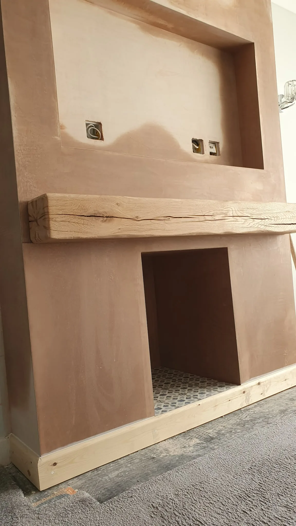 Plastered media wall with an oak beam mantel over the fire opening, Southport