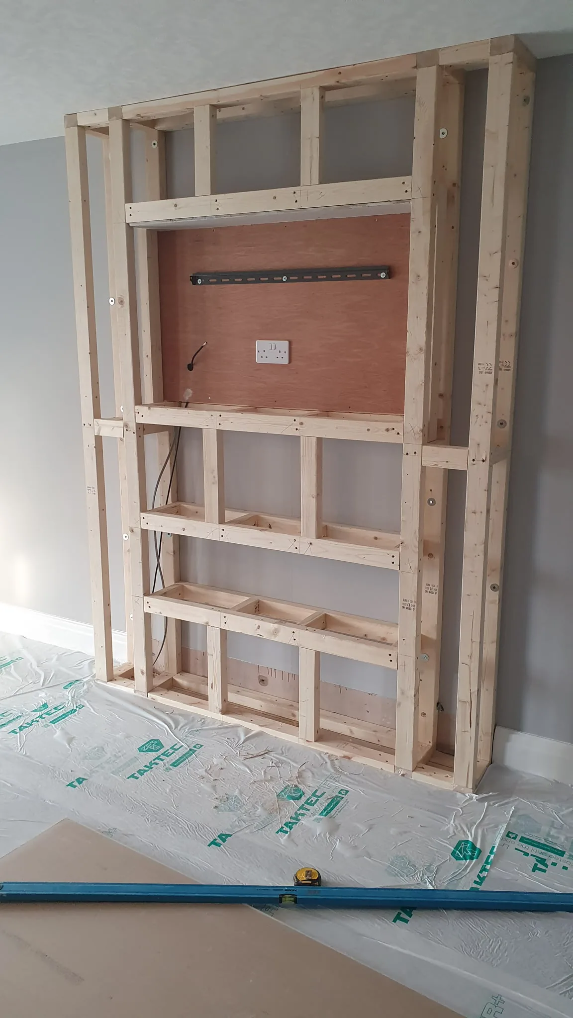 Timber stud frame for a media wall with TV bracket and socket, Southport