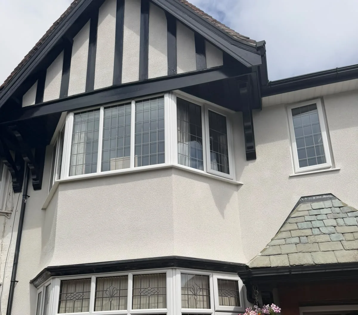Cream rendered Tudor-gable semi with twin bay windows in Southport