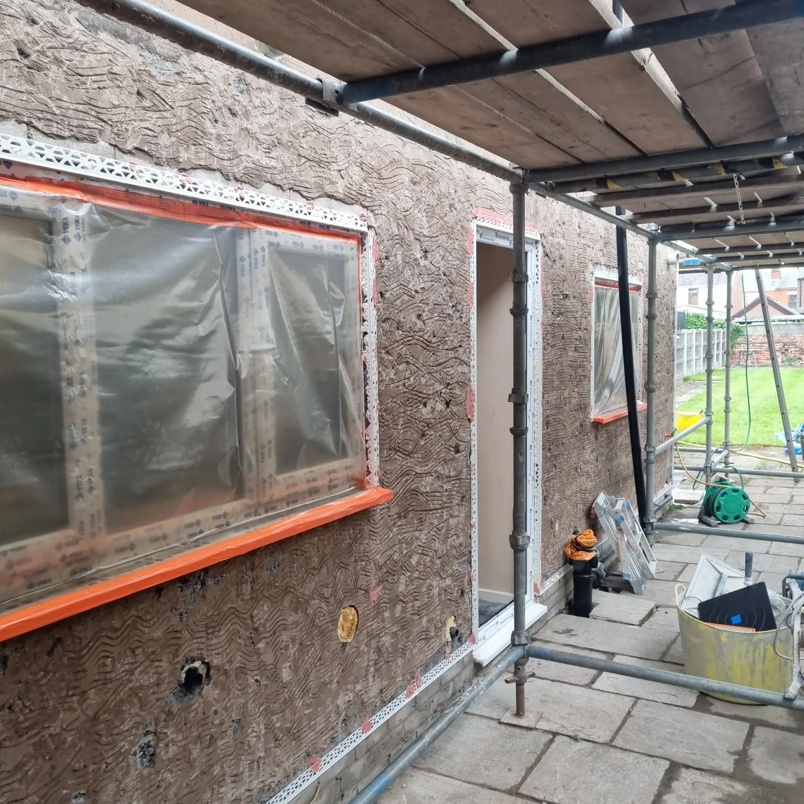 Combed scratch coat over stripped original brickwork on a period Southport house
