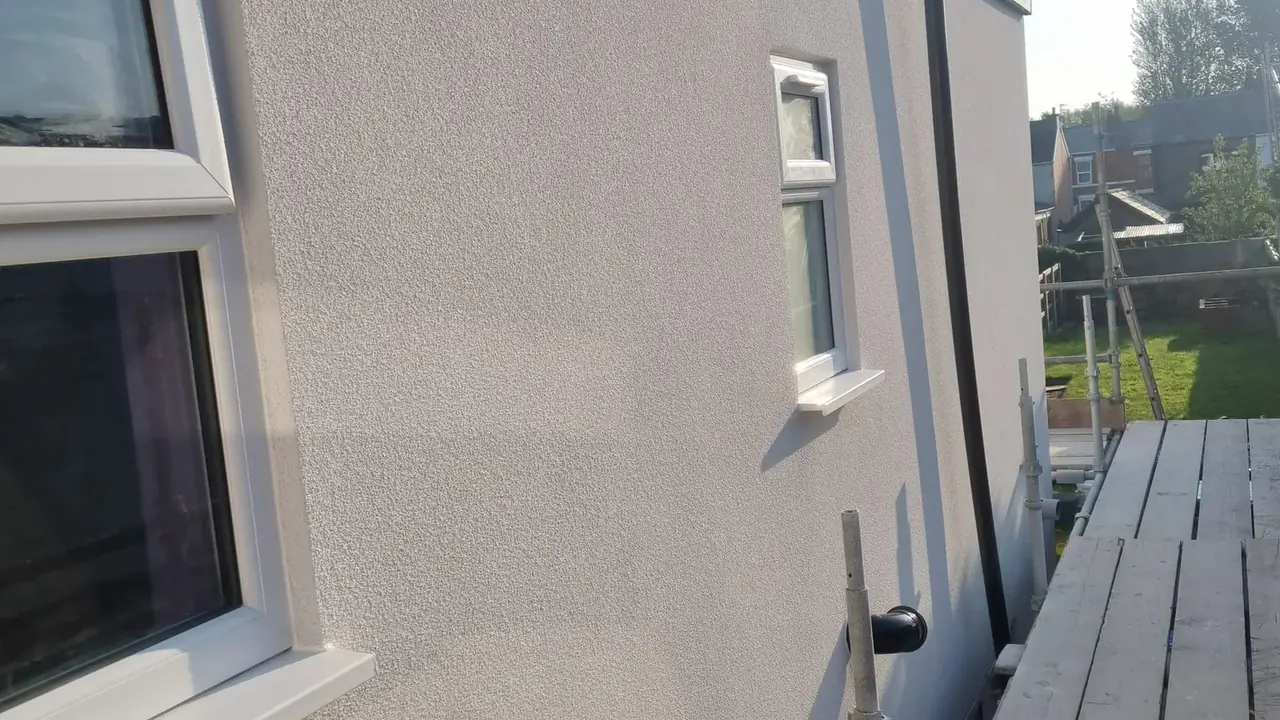 Silicone render finished on a Maghull elevation catching low sun