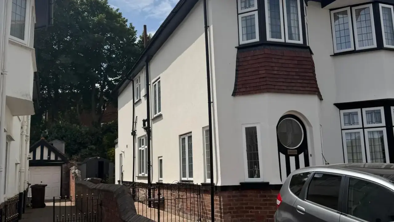 External rendering finished across the front and side elevation of a large house