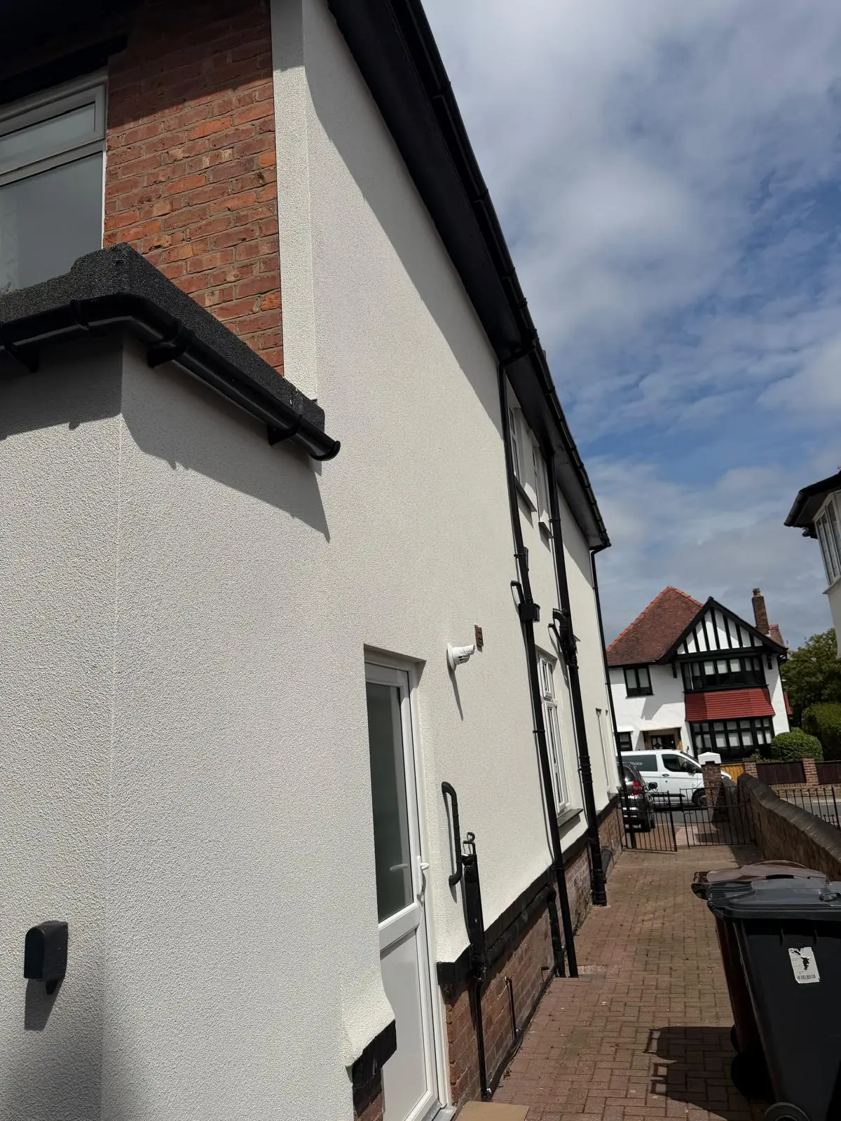 Silicone render finished on a gable elevation beside the original brickwork in Southport
