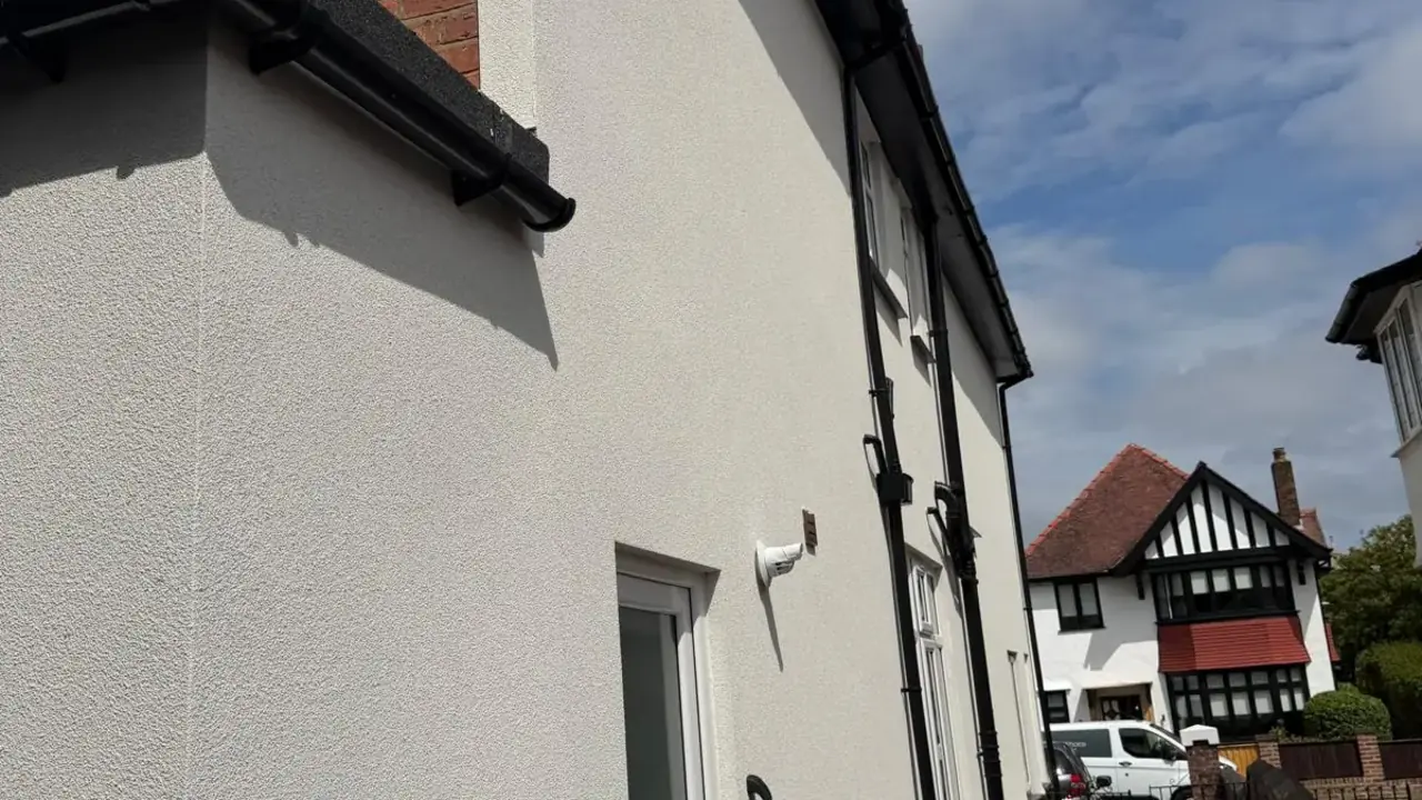 Silicone render finished on a gable elevation beside the original brickwork