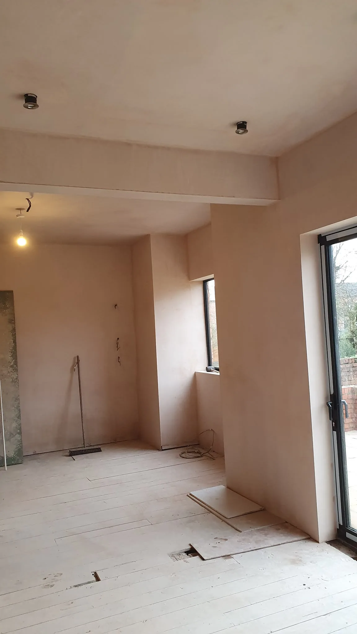 Freshly skimmed open-plan room with boxed beam and bi-fold doors, Southport