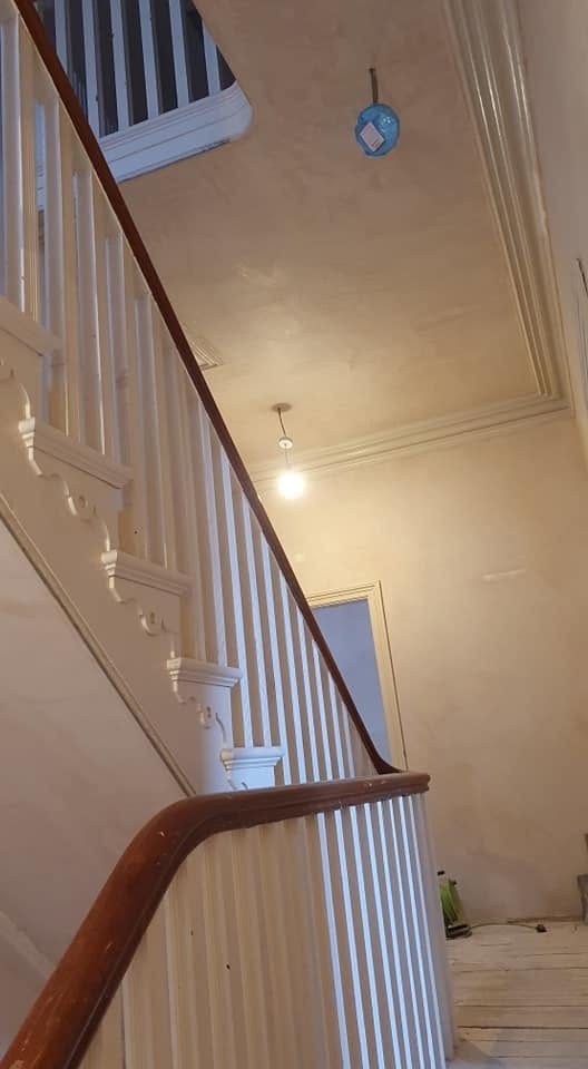 Skimmed stairwell walls and ceiling above the original spindles and handrail, Southport