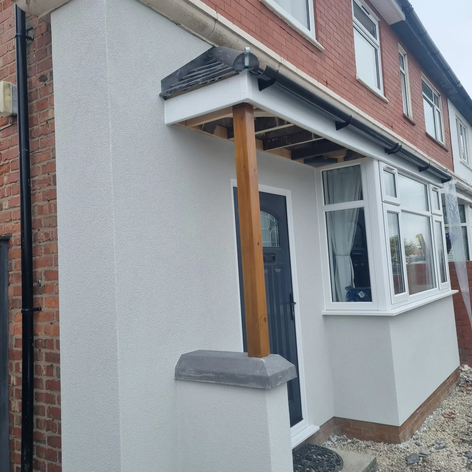 White render finished around a front porch, bay and timber post in Southport